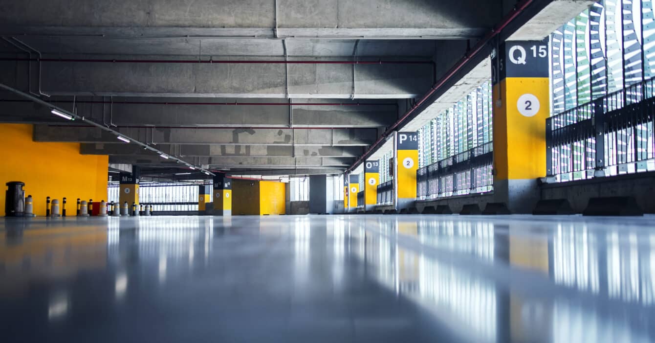 Empty garage with parking lots with concrete ceiling and flooring and pillars marked with numbers. Empty garage with parking lots with concrete ceiling and flooring and pillars marked with numbers.